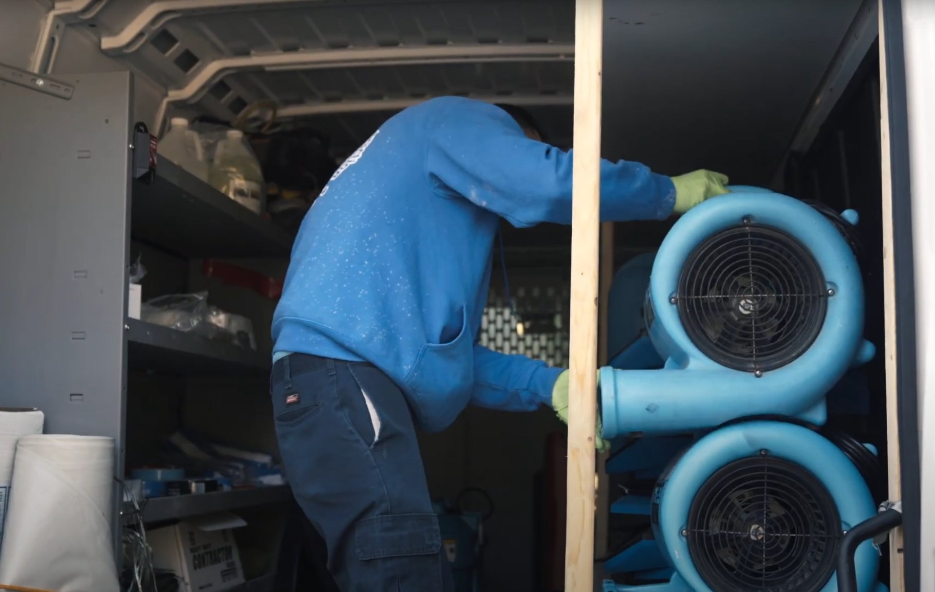 Professional drying and dehumidification equipment setup Professional water damage restoration technician working with drying equipment in Charleston basement