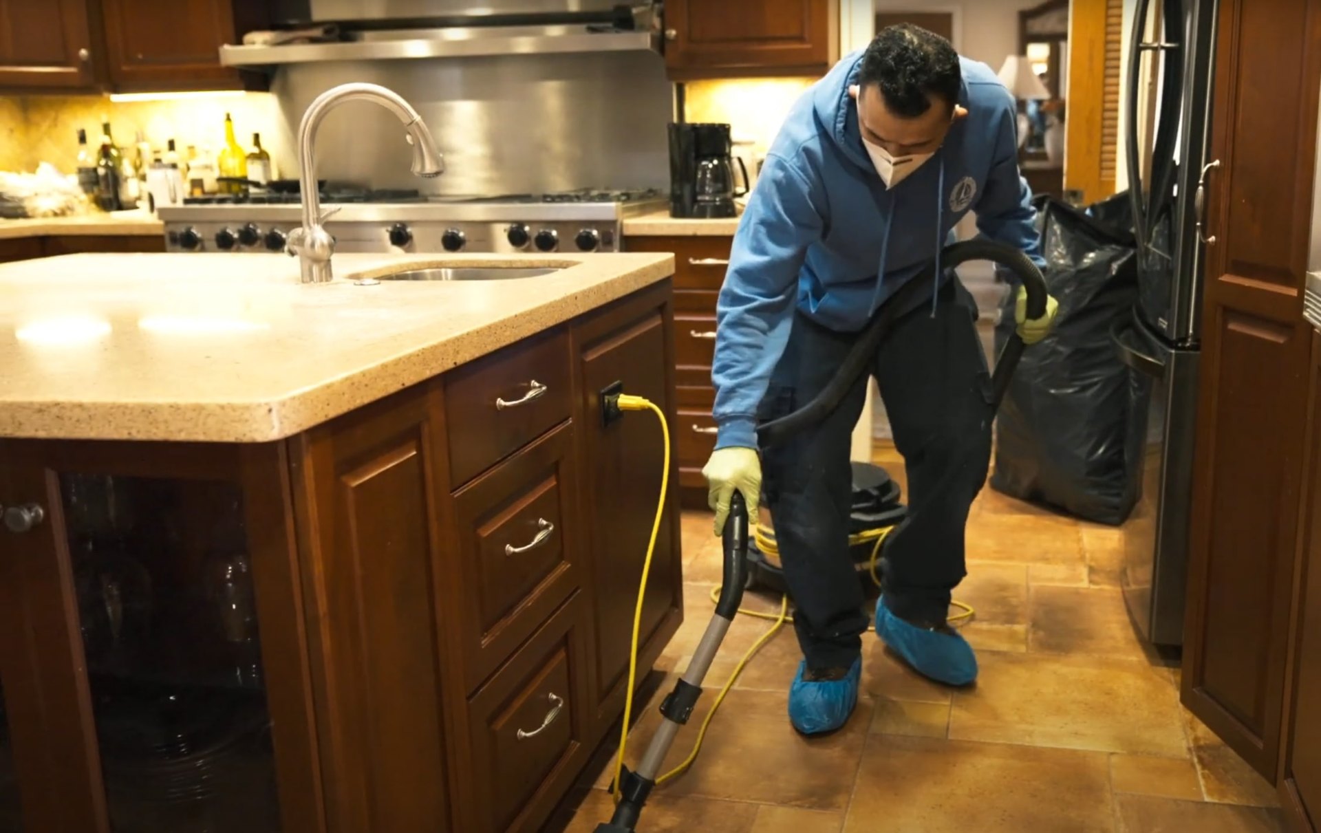 Emergency water extraction service in Charleston kitchen Professional water damage restoration technician using advanced water extraction equipment in a Charleston kitchen